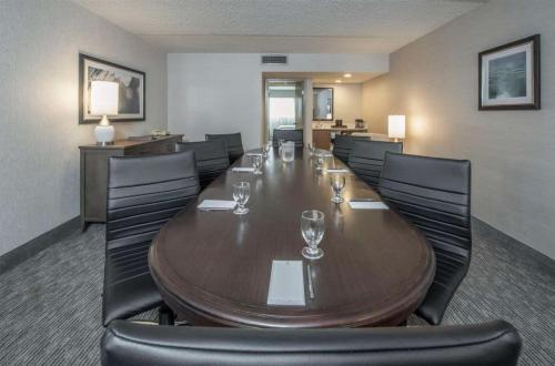 a conference room with a long wooden table and chairs at Embassy Suites by Hilton Chicago Schaumburg Woodfield in Schaumburg