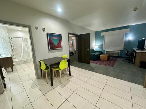 a living room with a table and yellow chairs at Home2 Suites By Hilton Amarillo East in Amarillo