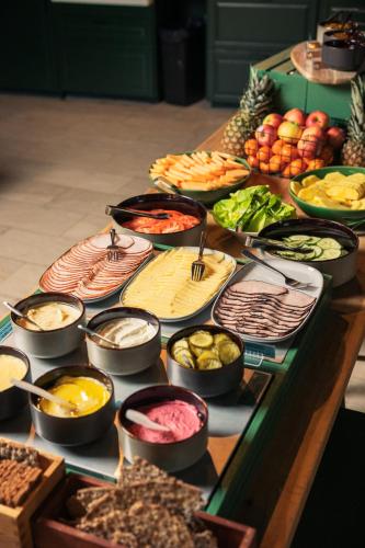 a table topped with lots of different types of food at Botanika Uppsala in Uppsala