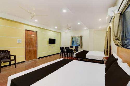 a hotel room with a bed and a tv at Hotel O SVR Grand Inn in Surūrnagar