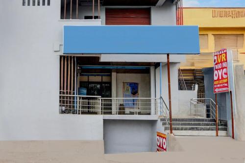 a blue sign on the side of a building at Hotel O SVR Grand Inn in Surūrnagar