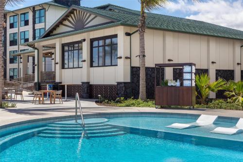 a house with a swimming pool in front of a house at Hampton Inn & Suites Maui North Shore in Kahului