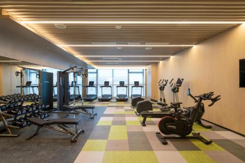 a gym with treadmills and exercise equipment in a building at Doubletree By Hilton Guang'An in Guang'an