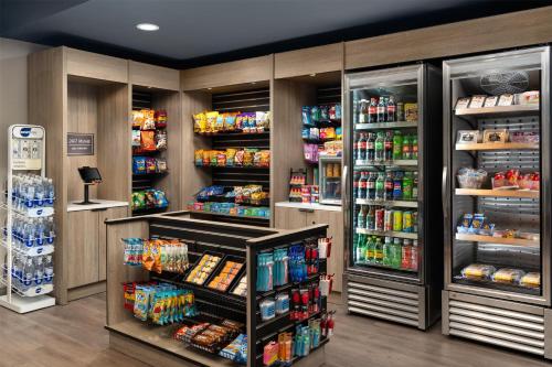 a grocery store aisle with drinks and food at Hyatt Studios Mobile/Tillmans Corner in Mobile