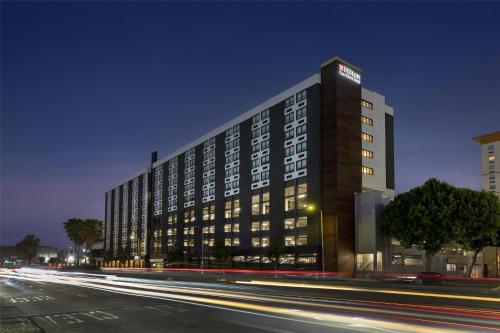 a tall building on a city street at night at Hilton Garden Inn LAX Los Angeles Airport in Los Angeles