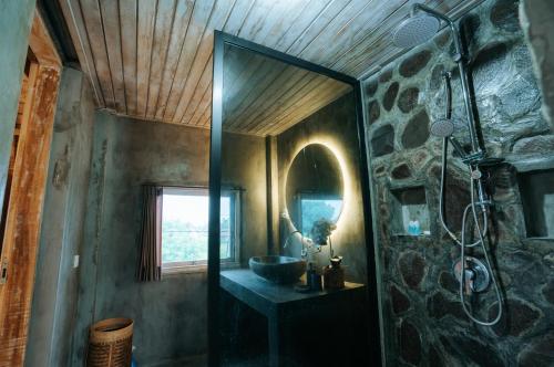a bathroom with a sink and a mirror at Vila Buruan in Mantaak