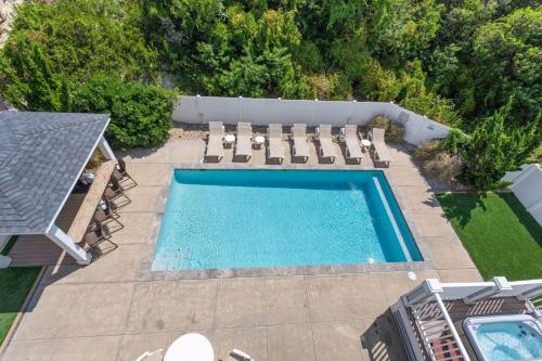 an overhead view of a swimming pool with chaise lounge chairs and a swimming pool at 1617 - Point Break in Corolla