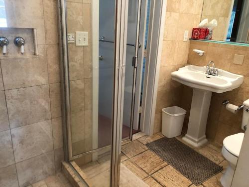 a bathroom with a shower and a sink and a toilet at Lake avenue 21 in Rehoboth Beach