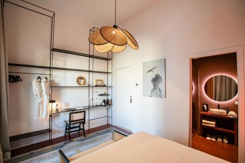 a bedroom with a bed and a mirror at Palazzo Piccinno in Parabita