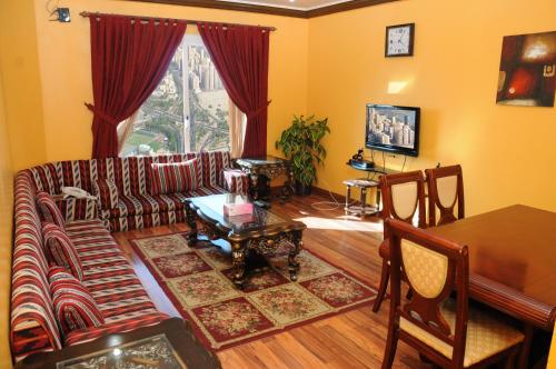 a living room with a couch and a table at Arinza Tower Quality Apartments in Kuwait