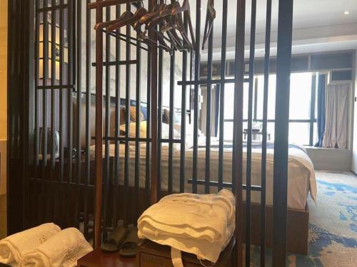 a bedroom with a cage with a bed in it at Yuan Culture Hotel Shenzhen World Shajing in Shenzhen