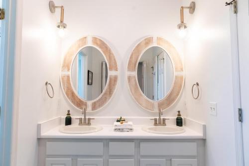 three mirrors above two sinks in a bathroom at 18 Veranda Beach Drive in Fripp Island
