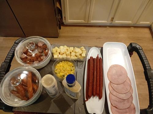 a table topped with lots of different types of food at The Breakfast Suite with 2 Queen beds in Fraser Valley Getaway R1 in Abbotsford