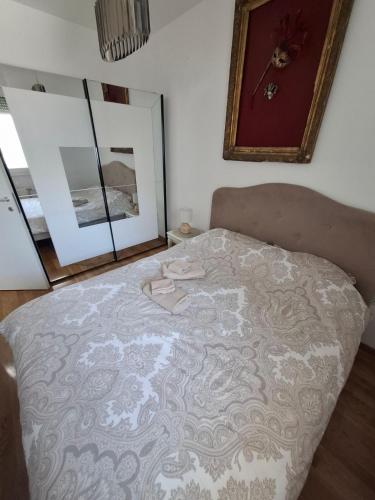 a large bed in a bedroom with a mirror at Eleon in Petrovaradin