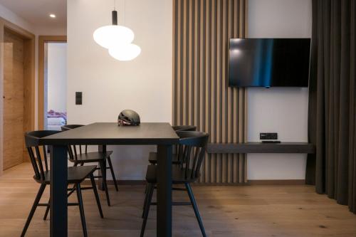 a dining room with a table and chairs at Neueröffnung ELVA PREMIUM APARTMENT HOTEL inklusive Sommerpass STUBAI SUPER CARD in Neustift im Stubaital