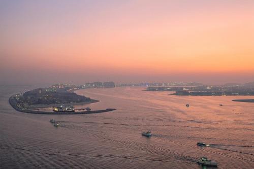 an aerial view of a river at sunset at Beachfront 2BR Grand Bleu Luxe Near Dubai Palm & Marina Hotspots in Dubai