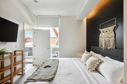 a bedroom with a large bed with a black headboard at Japandi Minimalism | Espadin LoHi in Denver