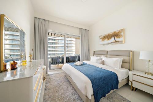 a bedroom with a large bed and a window at Beachfront 2BR Grand Bleu Luxe Near Dubai Palm & Marina Hotspots in Dubai