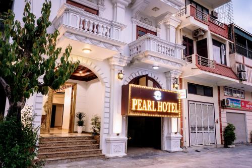 a large white building with a sign that reads park house at Pearl Hotel Ha Long in Ha Long