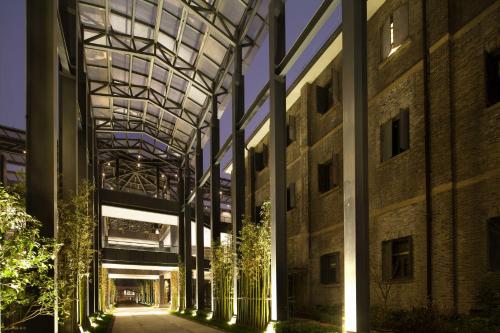 an external view of a building at night at Cheery Dragon Canal Hotel Hangzhou - Intangible Cultural Heritage Hotel in Hangzhou