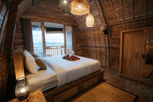 a bedroom with a bed in a log cabin at Vila Buruan in Mantaak