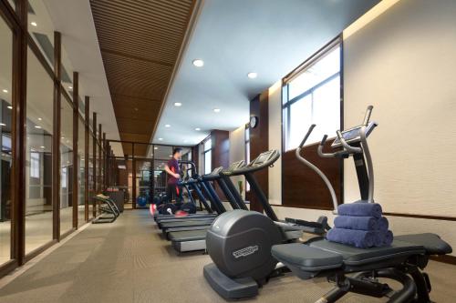a row of exercise bikes in a gym at Cheery Dragon Canal Hotel Hangzhou - Intangible Cultural Heritage Hotel in Hangzhou