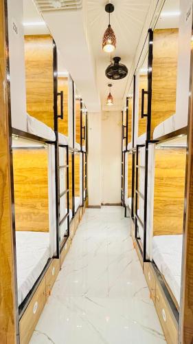a row of bunk beds in a room with a hallway at LF Hotels in Kozhikode