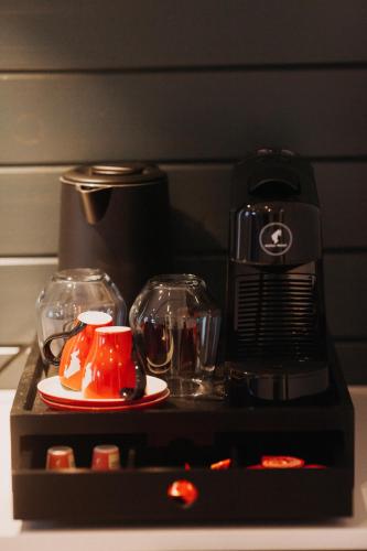 a kitchen with a coffee maker and a plate of food at Szépasszony Guest House in Vlăhiţa