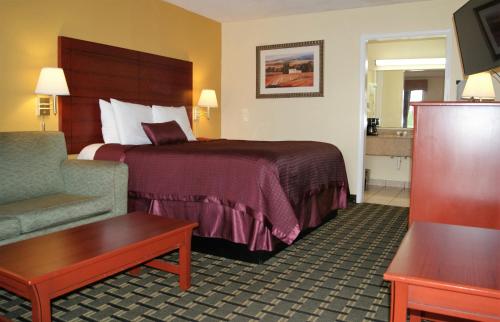 Säng eller sängar i ett rum på Red Carpet Inn - Natchez