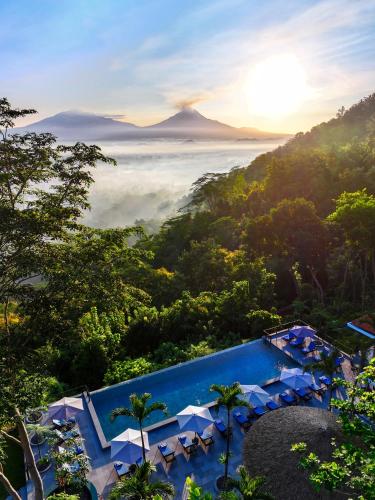 a view of a resort with a pool and a mountain at Villa Borobudur Resort in Borobudur