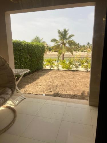 a sliding glass door with a view of a beach at Hawana salalah Forest island L3-G01 in Salalah