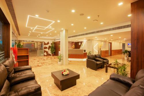 a large living room with couches and a basketball hoop at Hotel Laals Inn Grand By Jesway Hotels and Resorts in Cochin
