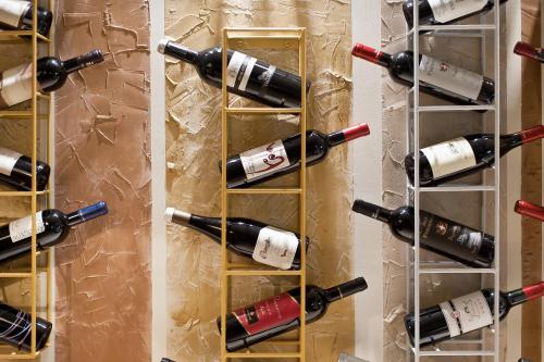 a bunch of wine bottles on a wall at Hotel Stella Della Versilia in Marina di Massa