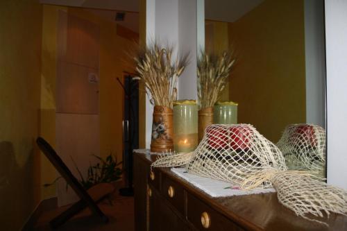 a dresser with vases sitting on top of it at La Baita in Livinallongo del Col di Lana