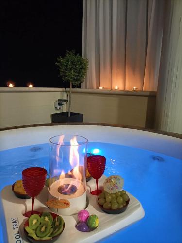 a candle and some cookies in a bath tub at Comfort &Relax B&B&Spa in Villa Rosa