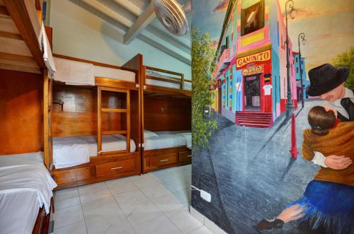 a room with two bunk beds and a mural of a bus at The Wandering Paisa in Medellín