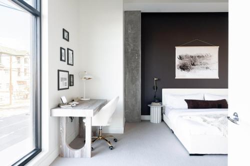 a bedroom with a white desk and a bed at Relaxed Elegance | Espadin LoHi in Denver