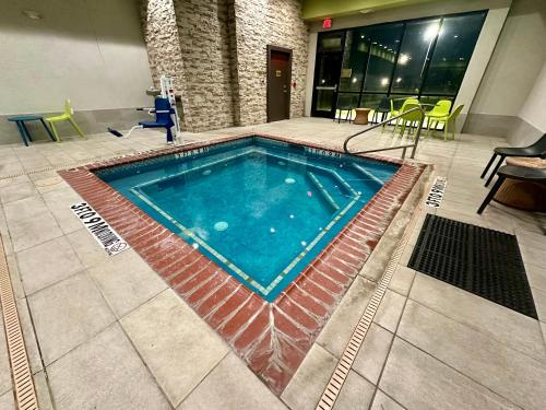 a large swimming pool in a building at Home2 Suites By Hilton Amarillo East in Amarillo