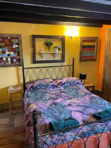 a bedroom with a bed with a colorful comforter at OYO Yarm Cottages in Kirk Leavington
