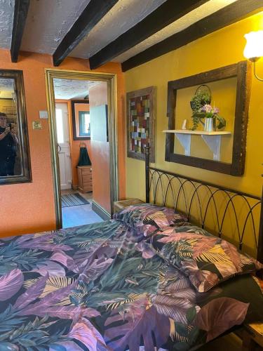 a bedroom with a bed with a colorful comforter at OYO Yarm Cottages in Kirk Leavington