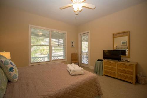 a bedroom with a bed and a flat screen tv at 423 Wahoo Dr in Fripp Island