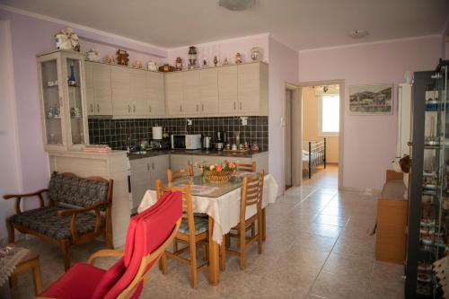a kitchen and dining room with a table and chairs at Irida Suite in Salamís