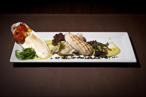 a white plate of food on a table at Hotel Stella Della Versilia in Marina di Massa