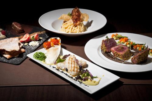 a group of plates of food on a table at Hotel Stella Della Versilia in Marina di Massa