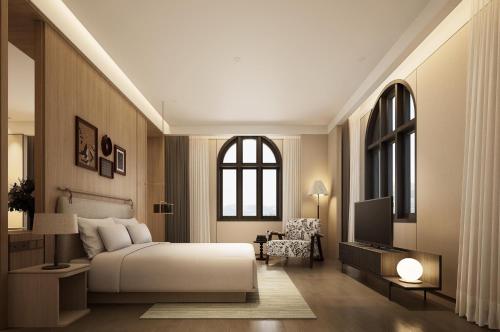 a bedroom with a bed and a tv in it at Horkeo Boutique Hotel in Xam Nua