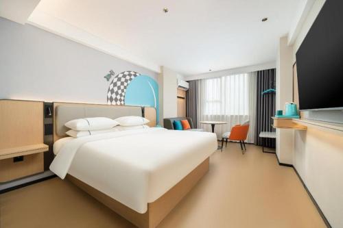 Postel nebo postele na pokoji v ubytování City Comfort Inn Beihai Hepu Bus Terminal