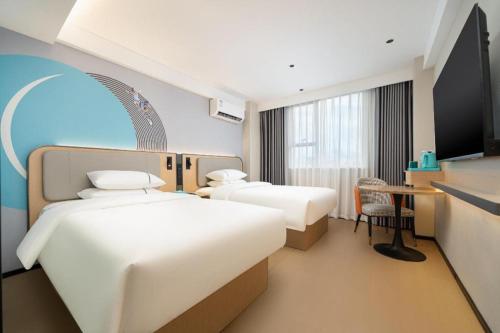 Postel nebo postele na pokoji v ubytování City Comfort Inn Beihai Hepu Bus Terminal