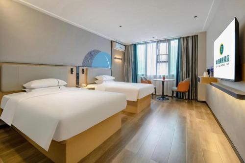 Postel nebo postele na pokoji v ubytování City Comfort Inn Beihai Hepu Bus Terminal