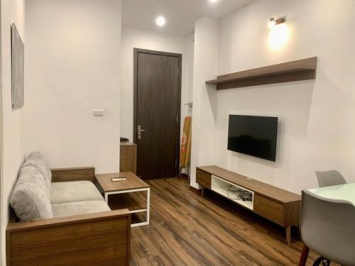 a living room with a couch and a flat screen tv at Bảo An Homestay Thái Nguyên in Thái Nguyên