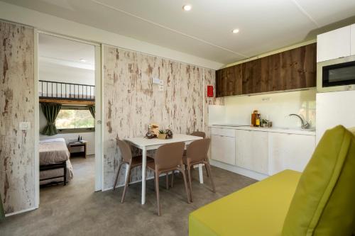 a kitchen and dining room with a table and chairs at Palagina Il Borgo Agricolo in Figline Valdarno